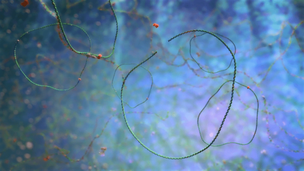 An abstract image features strands of cyanobacteria set against a blue and green background. The swirling, thread-like structures, reminiscent of genetic engineering processes, are scattered with small red particles, resembling an underwater or microscopic scene.